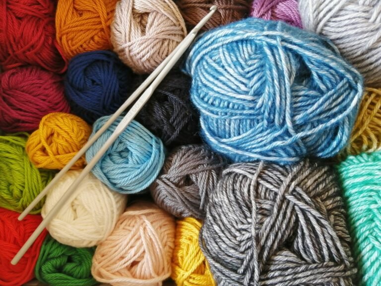 Orange, blue and cream yarn arranged for a granny square throw