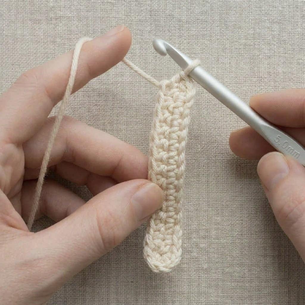 The work turned like the page of a book, with one loop on the hook, ready for the next row